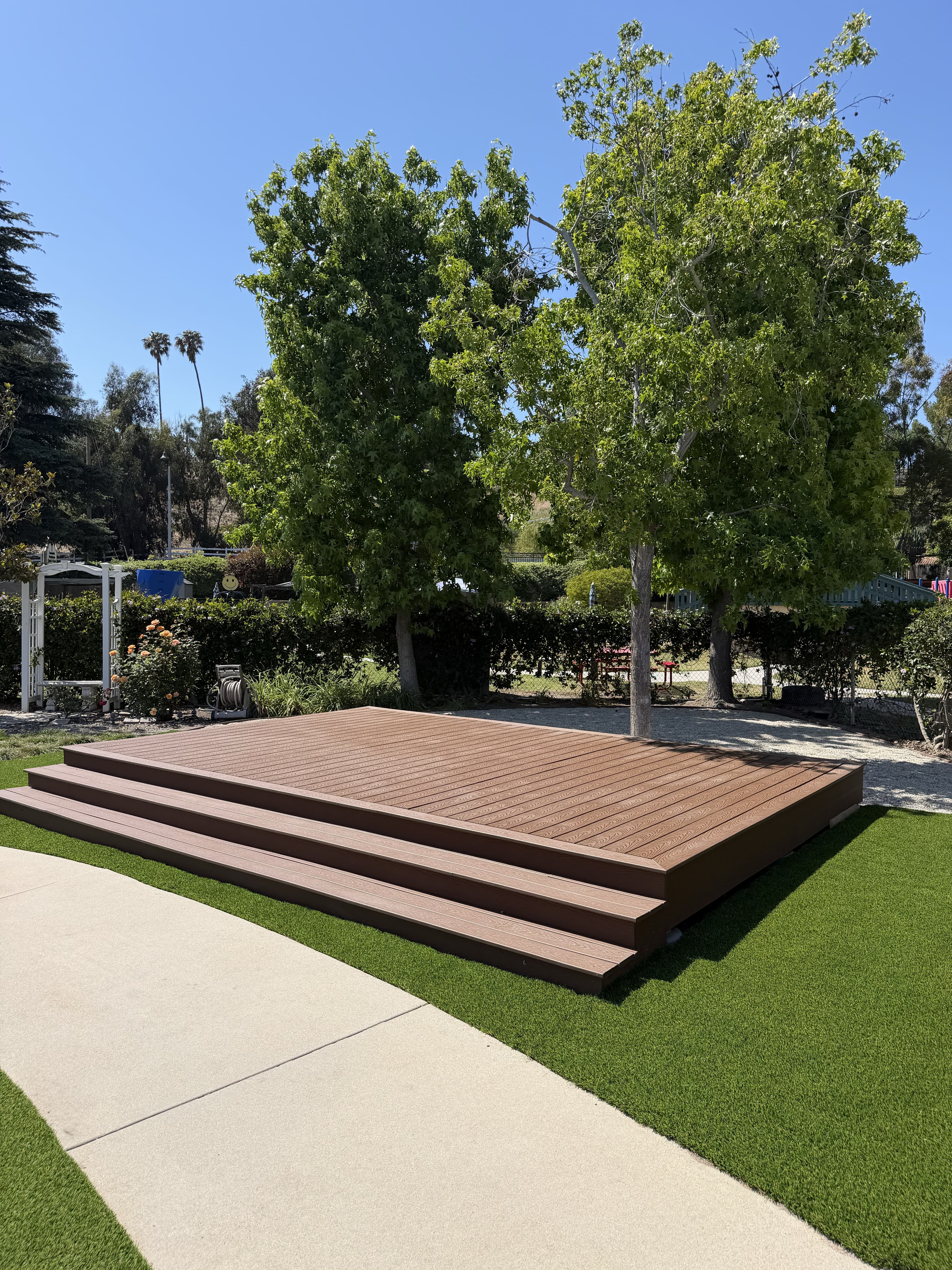18x14 freestanding Trex deck and stage platform built by Orange Path Landscaping